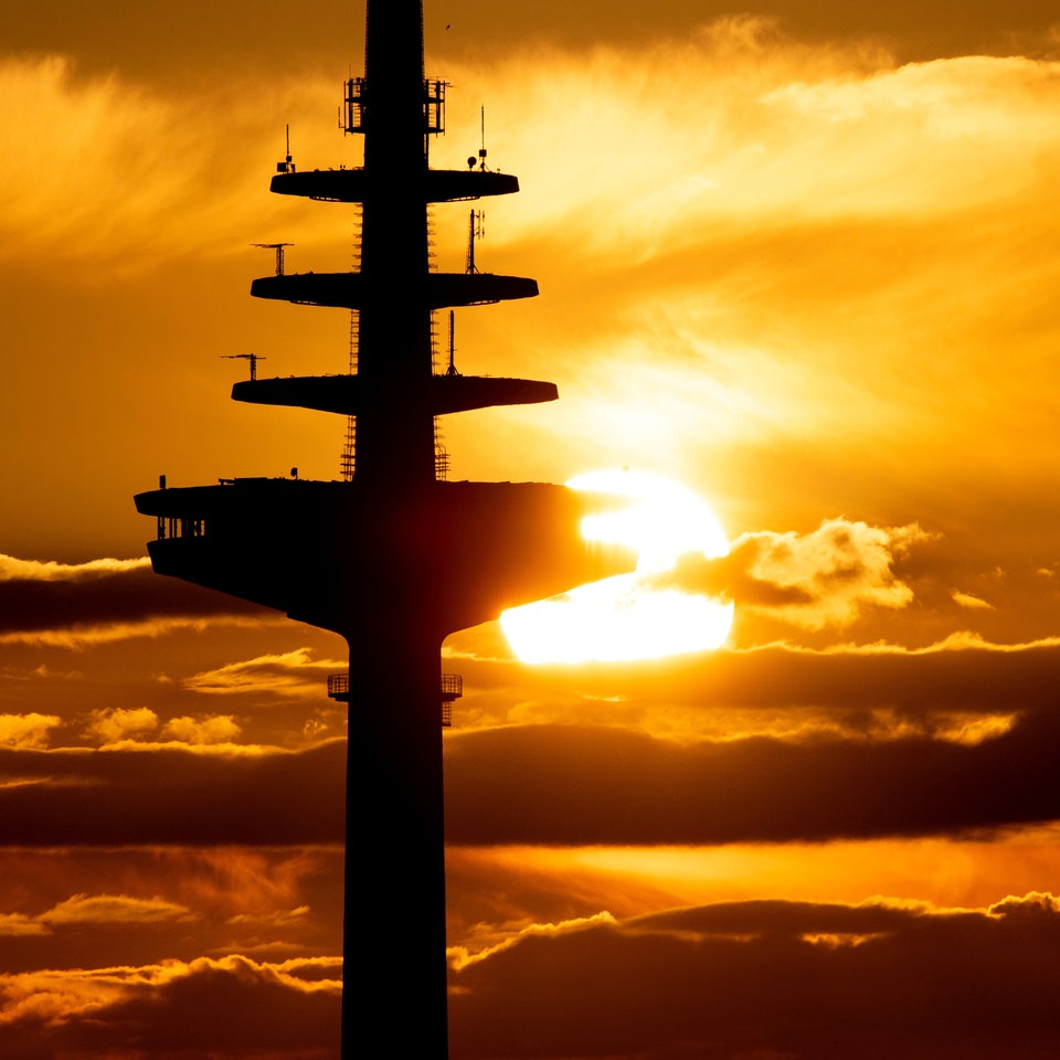 Die Sonne geht hinter dem Bremer Fernsehturm unter.